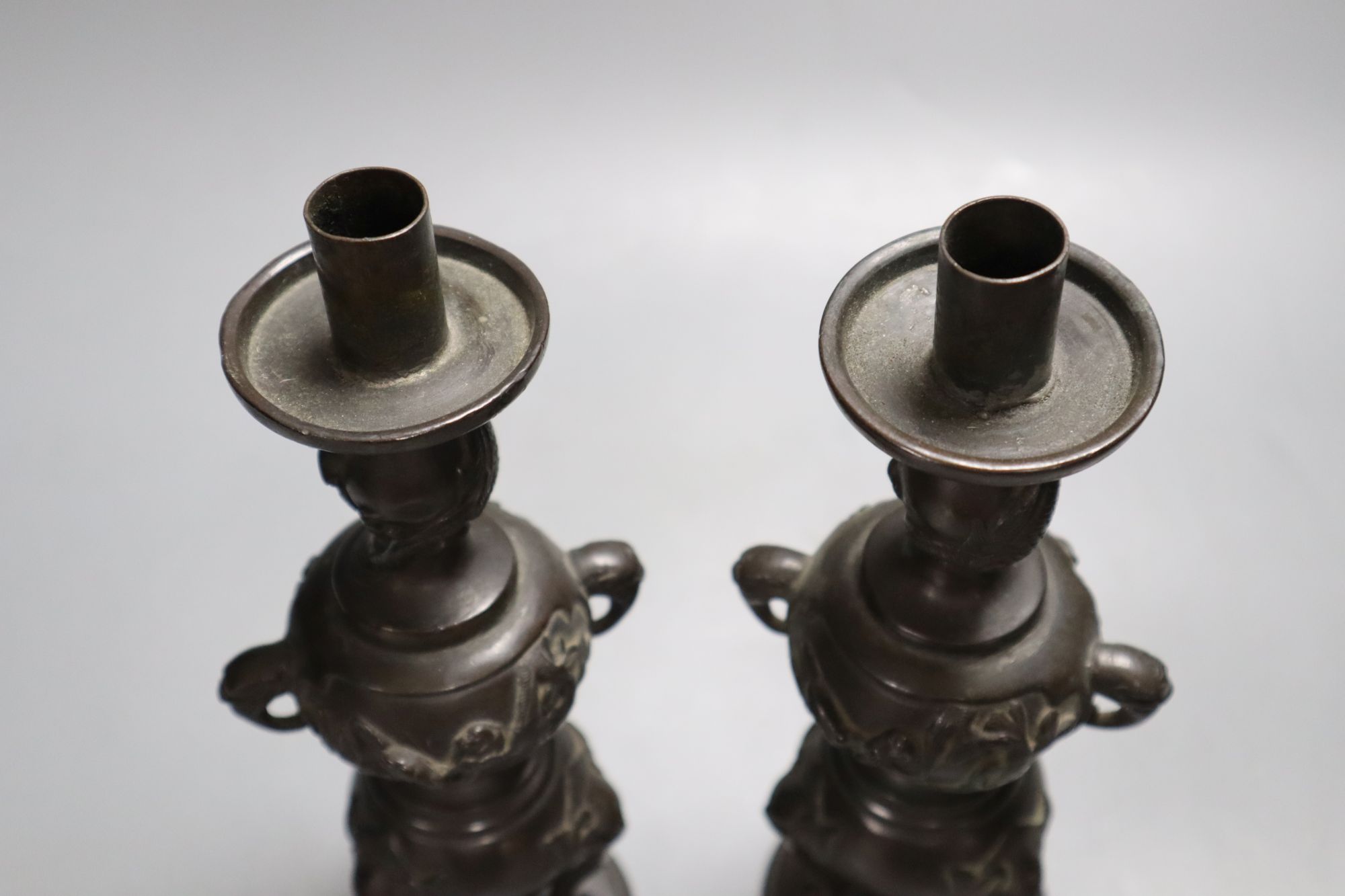 A pair of Japanese bronze candlesticks, Meiji period, height 23cm